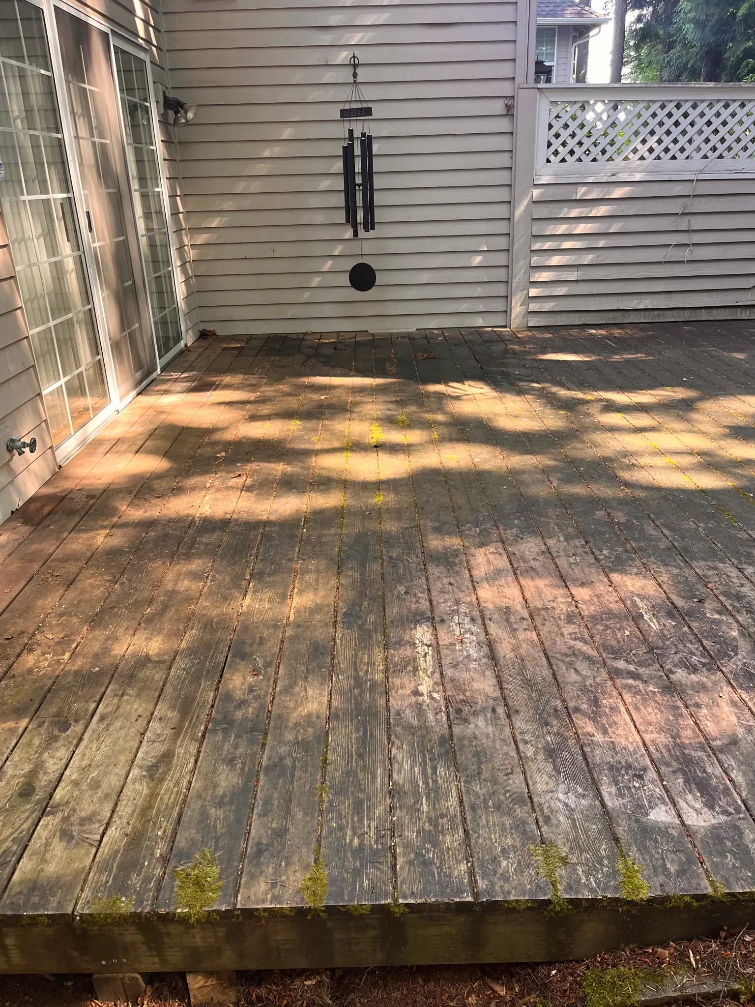 Before — Weathered gray backyard deck restored to rich clean cedar by soft washing