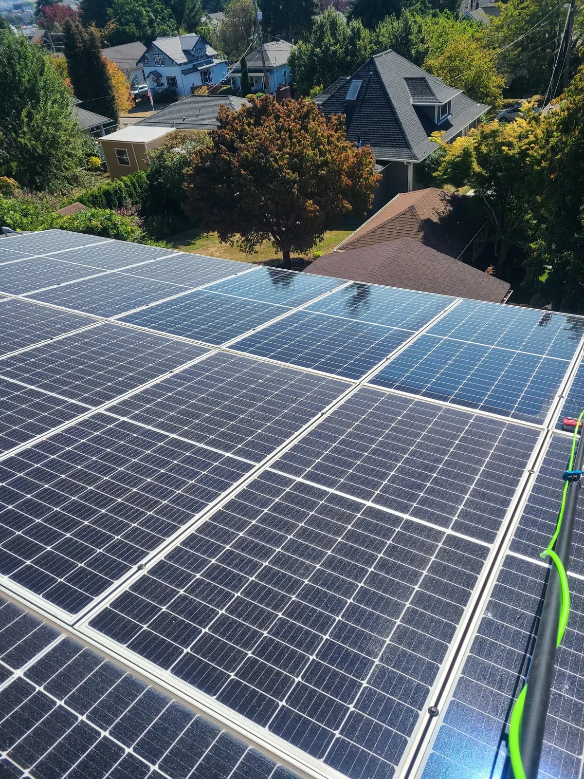 Before — Hazy solar panels being water-fed brushed, then spotless with crisp cells