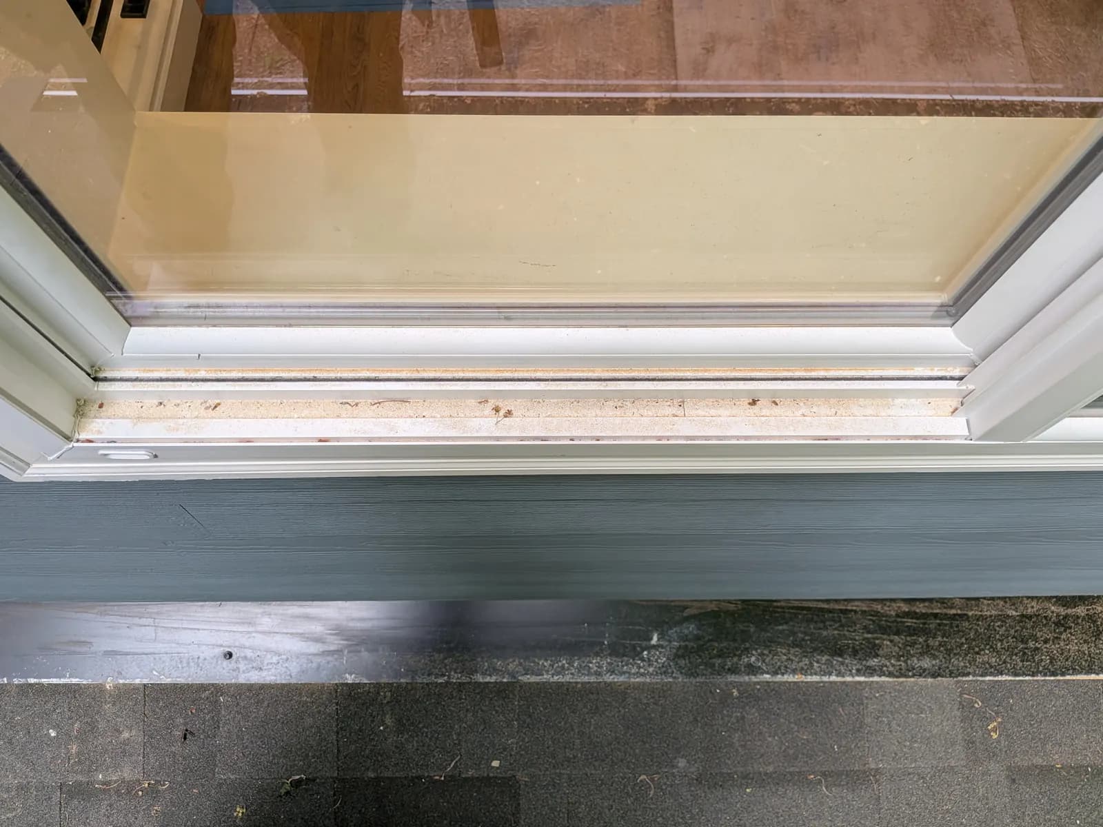 Before — Sliding-door track full of sand and debris, detailed to spotless white